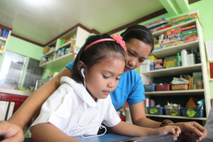 girl using tablet with mother