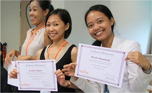 Picture of three women smiling and holding certificates. A solution for gifting education for christmas.