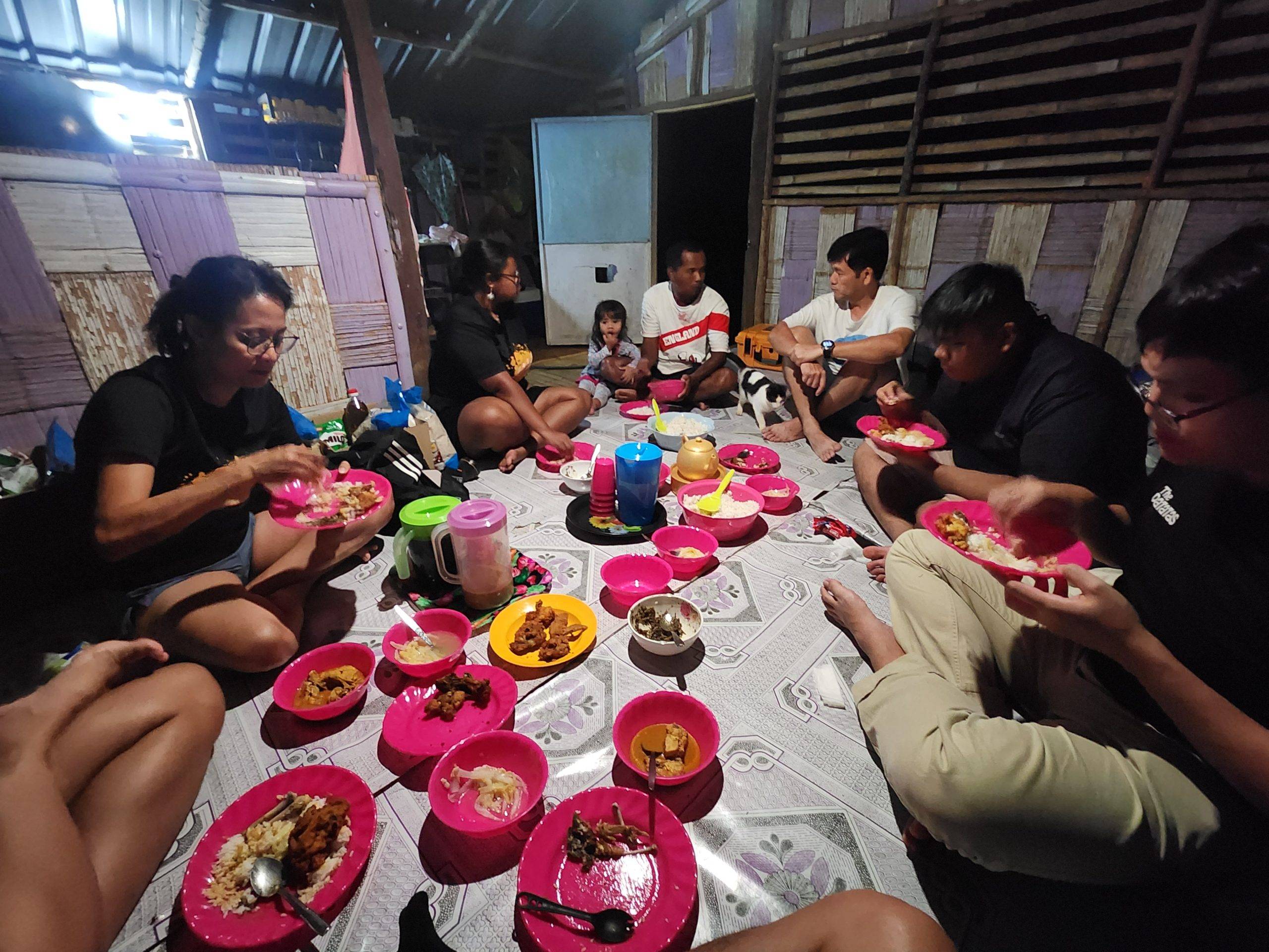 people sitting on floor and eating food